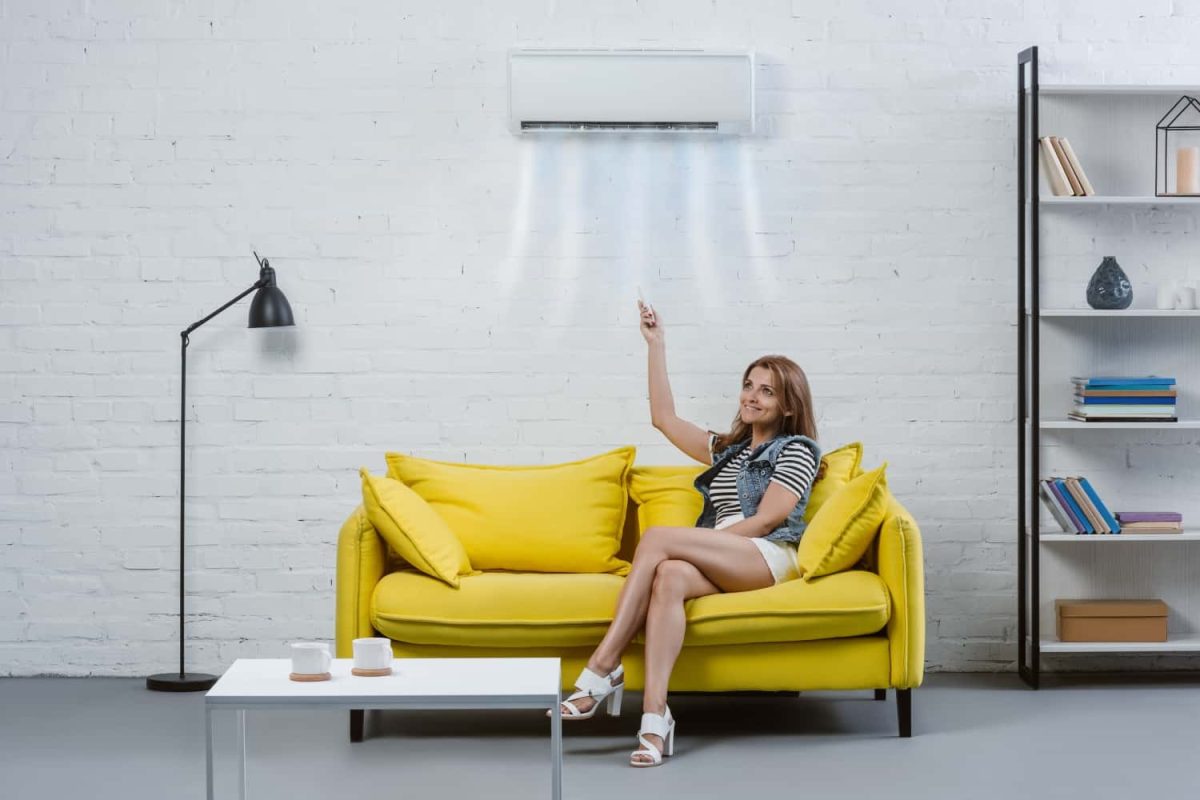 attractive-young-woman-pointing-at-air-conditioner-2022-12-16-20-14-43-utc-min.jpg