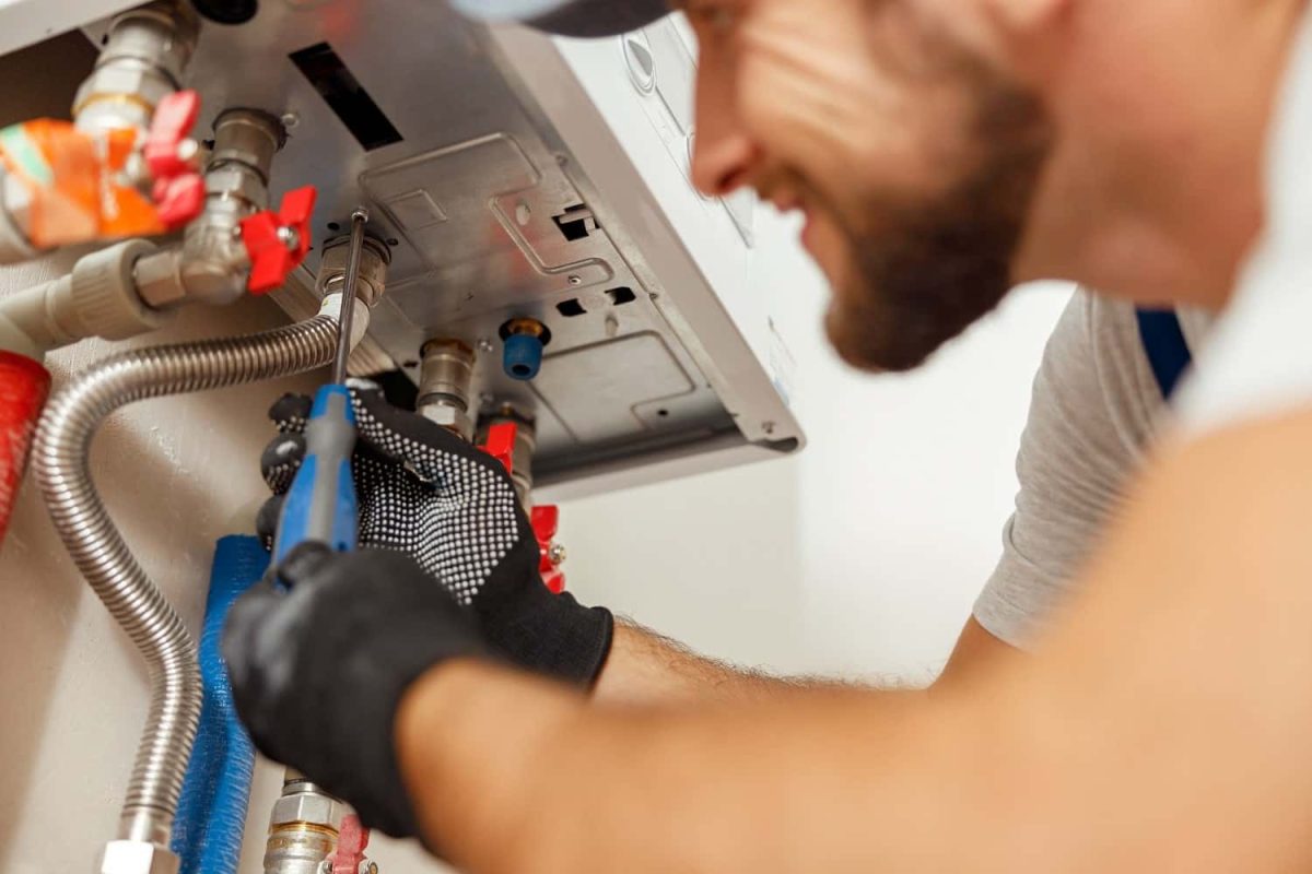 closeup-of-plumber-using-screwdriver-while-install-2022-03-09-03-07-35-utc-min-min.jpg