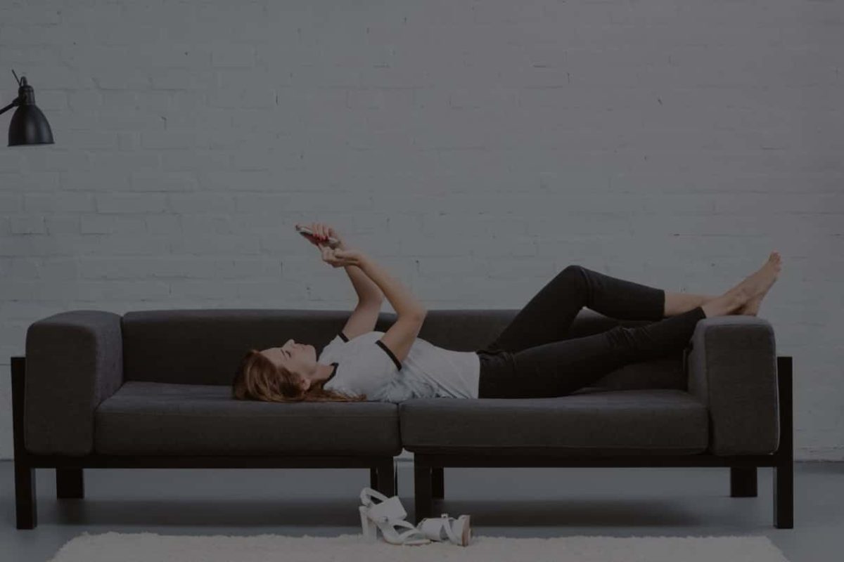 happy-young-woman-using-smartphone-on-sofa-under-a-2021-08-29-22-50-42-utc-min-min.jpg