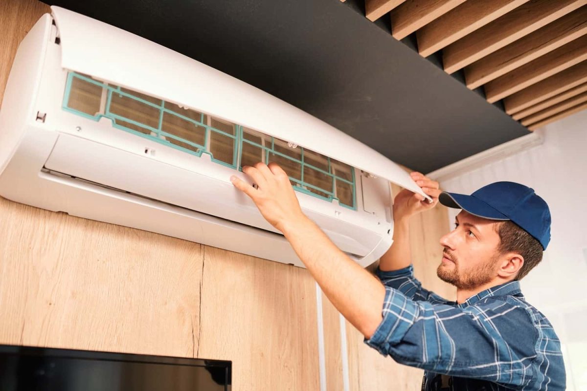 young-technician-opening-lid-of-air-conditioner-to-2021-09-24-03-09-41-utc-min-min.jpg